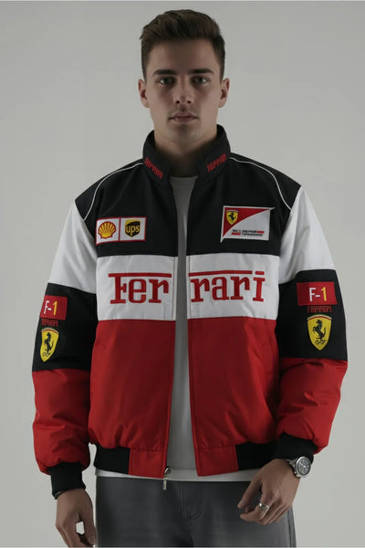 Person wearing a Ferrari jacket with various logos on a plain background