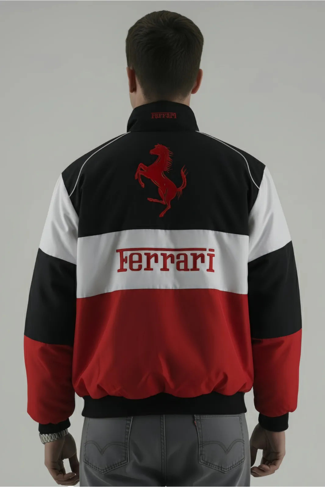 Person wearing a Ferrari jacket with red, white, and black design on a gray background