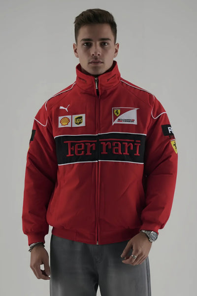 Person wearing a red Ferrari jacket with various logos on a gray background giving Front pose