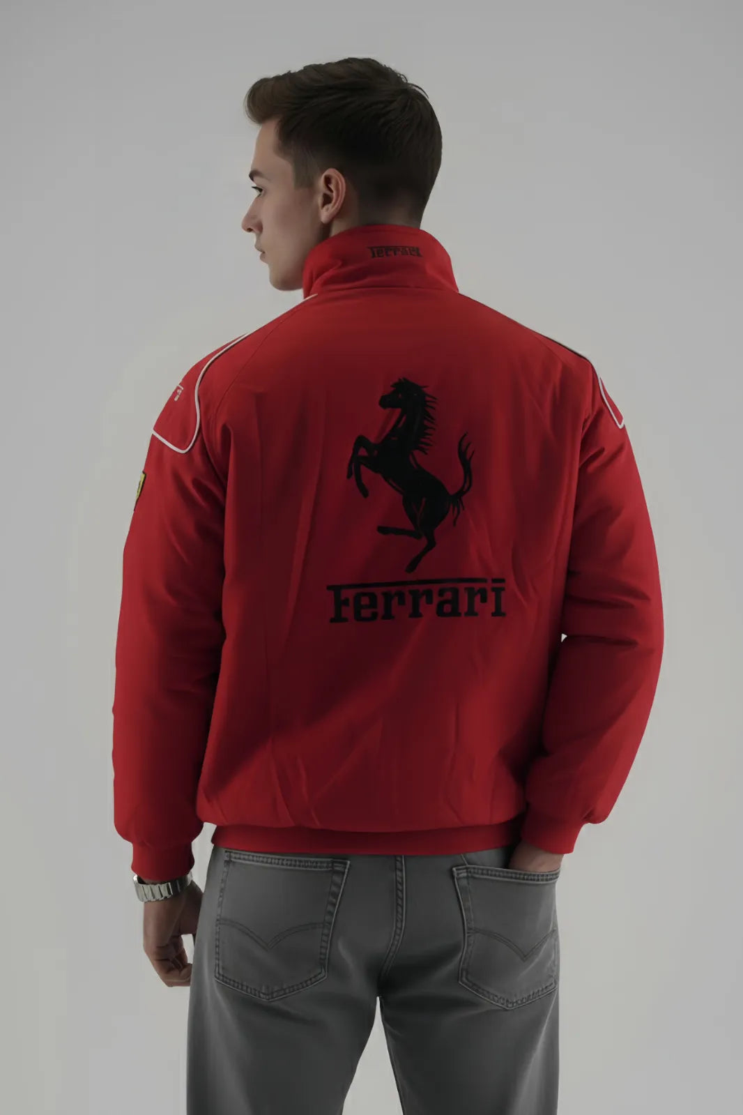 Person wearing a red Ferrari jacket with the brand logo on a plain giving background giving back pose