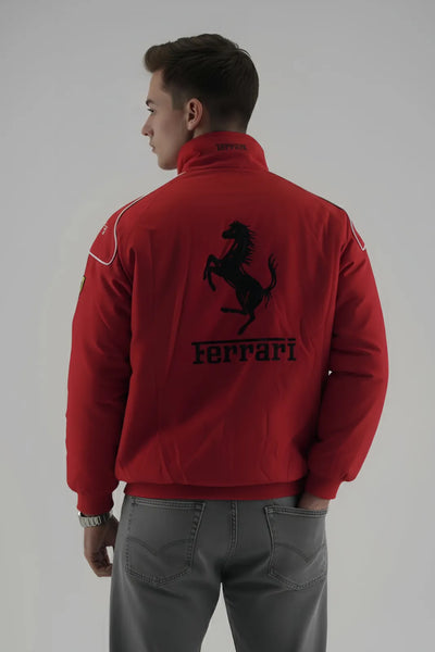 Person wearing a red Ferrari jacket with the brand logo on a plain giving background giving back pose