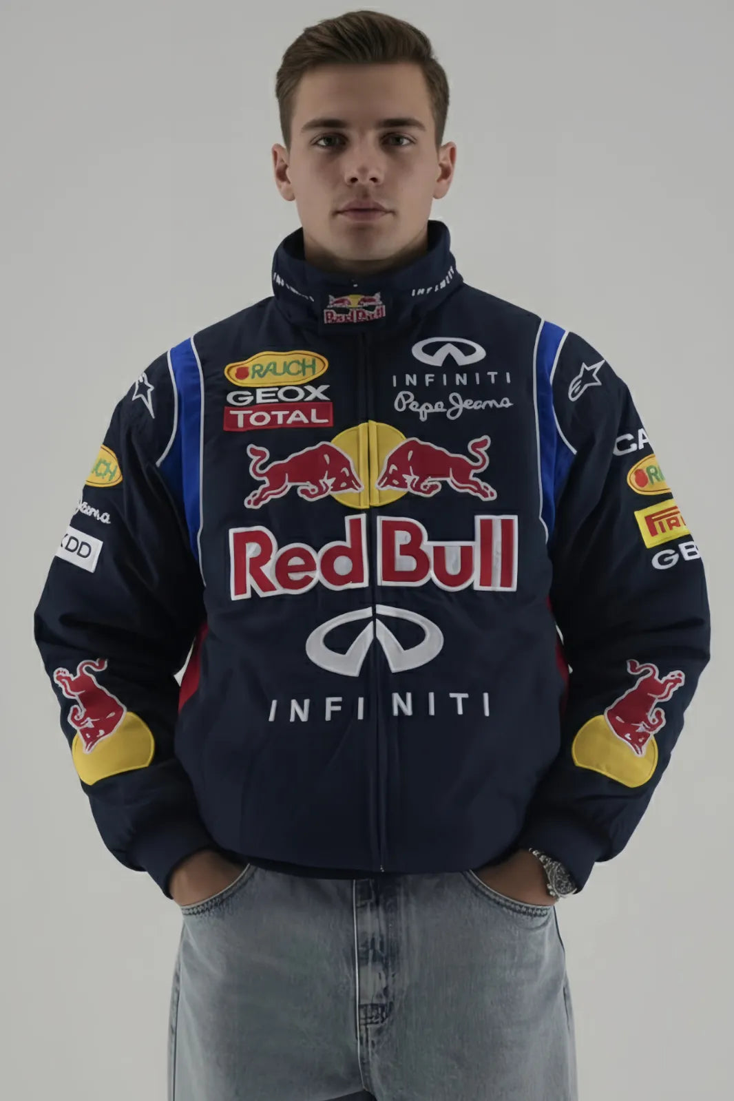 Person wearing a Red Bull F1 racing jacket with various sponsor logos on a plain background giving front pose 