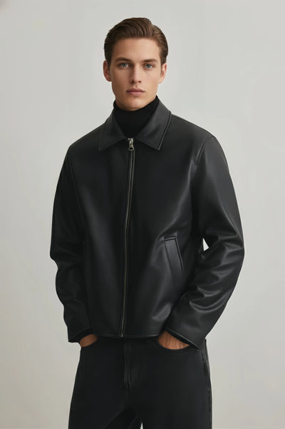 Man wearing a black leather jacket against a plain background