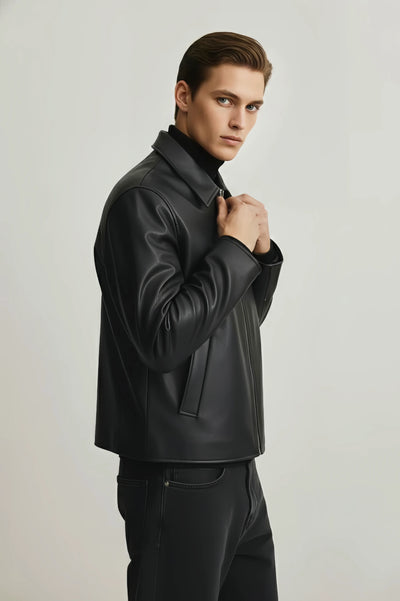 Man wearing a dark leather jacket on a light gray background