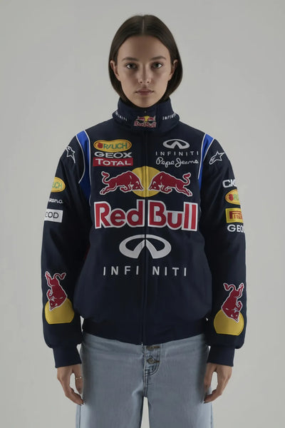 Female Model wearing a Red Bull racing jacket on a plain background giving front pose