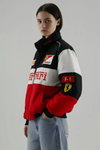 Close-up of the dense matte-thread embroided logos on the sleeves and chest of the Tricolor Ferrari jacket.